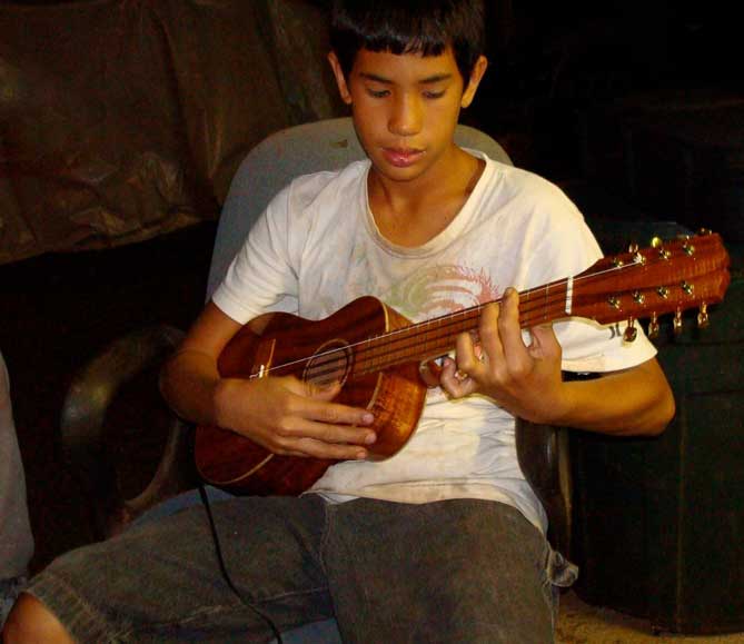 Makoa Palos playing ukulele after work